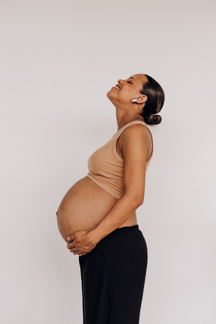 Black pregnant woman, nourished and at home in her body